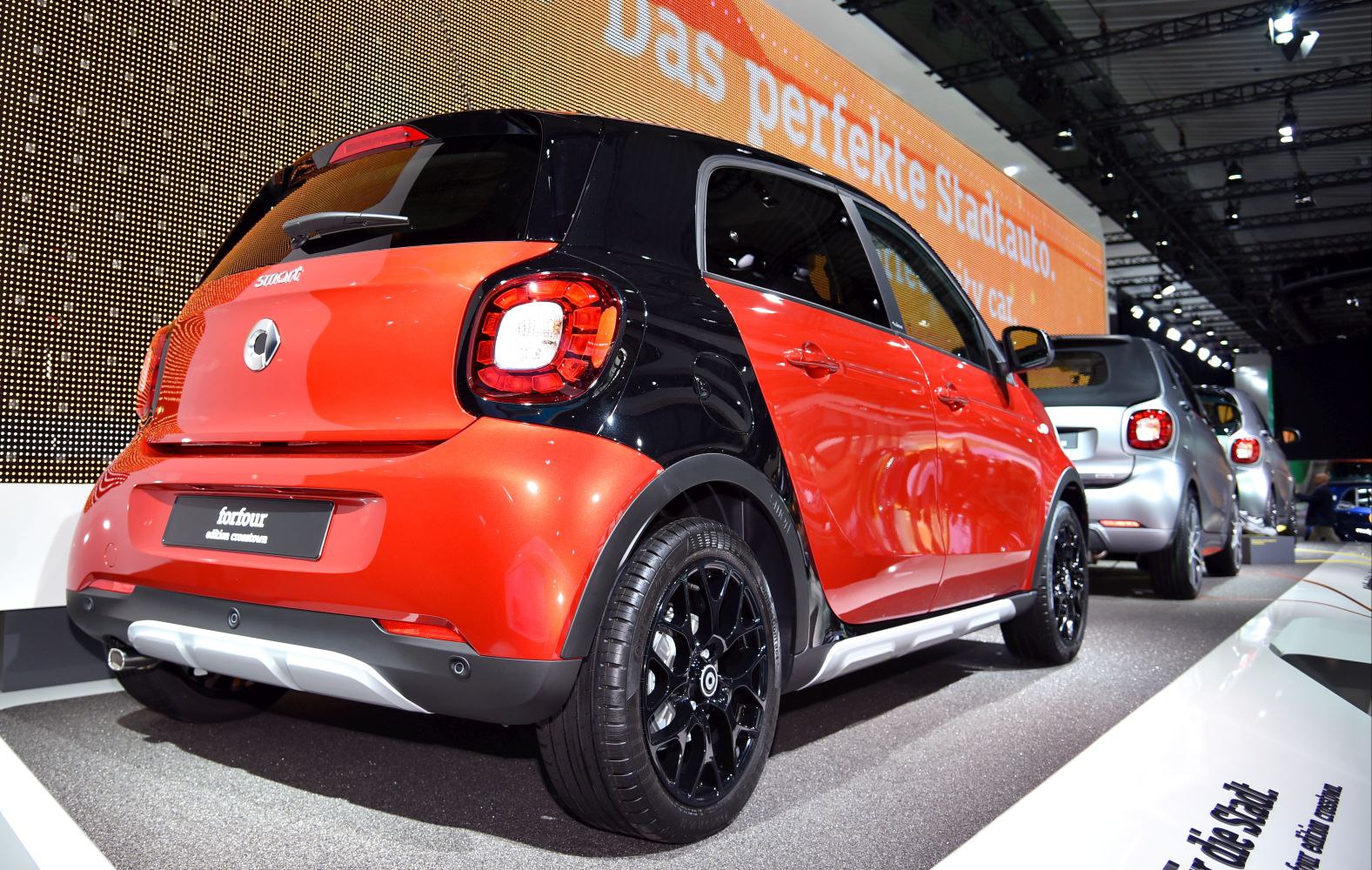 Rear view of a two-tone small hatchback with black alloy wheels