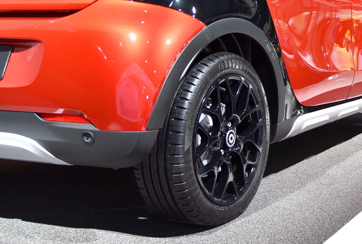 Black alloy wheel and rear fender close-up with tire tread detail