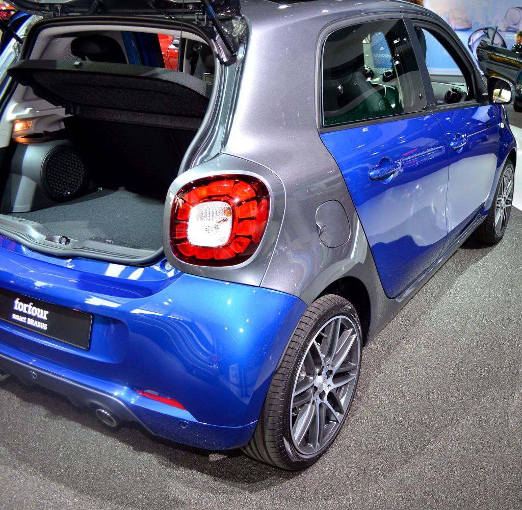 Open trunk and rear side view of compact hatchback.