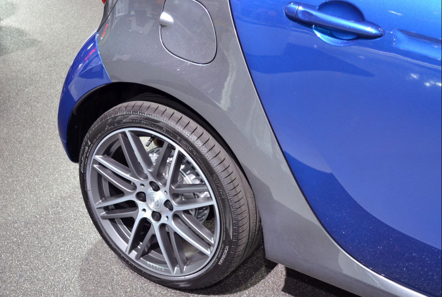 Close-up of alloy wheel and rear fender with fuel cap and door handle