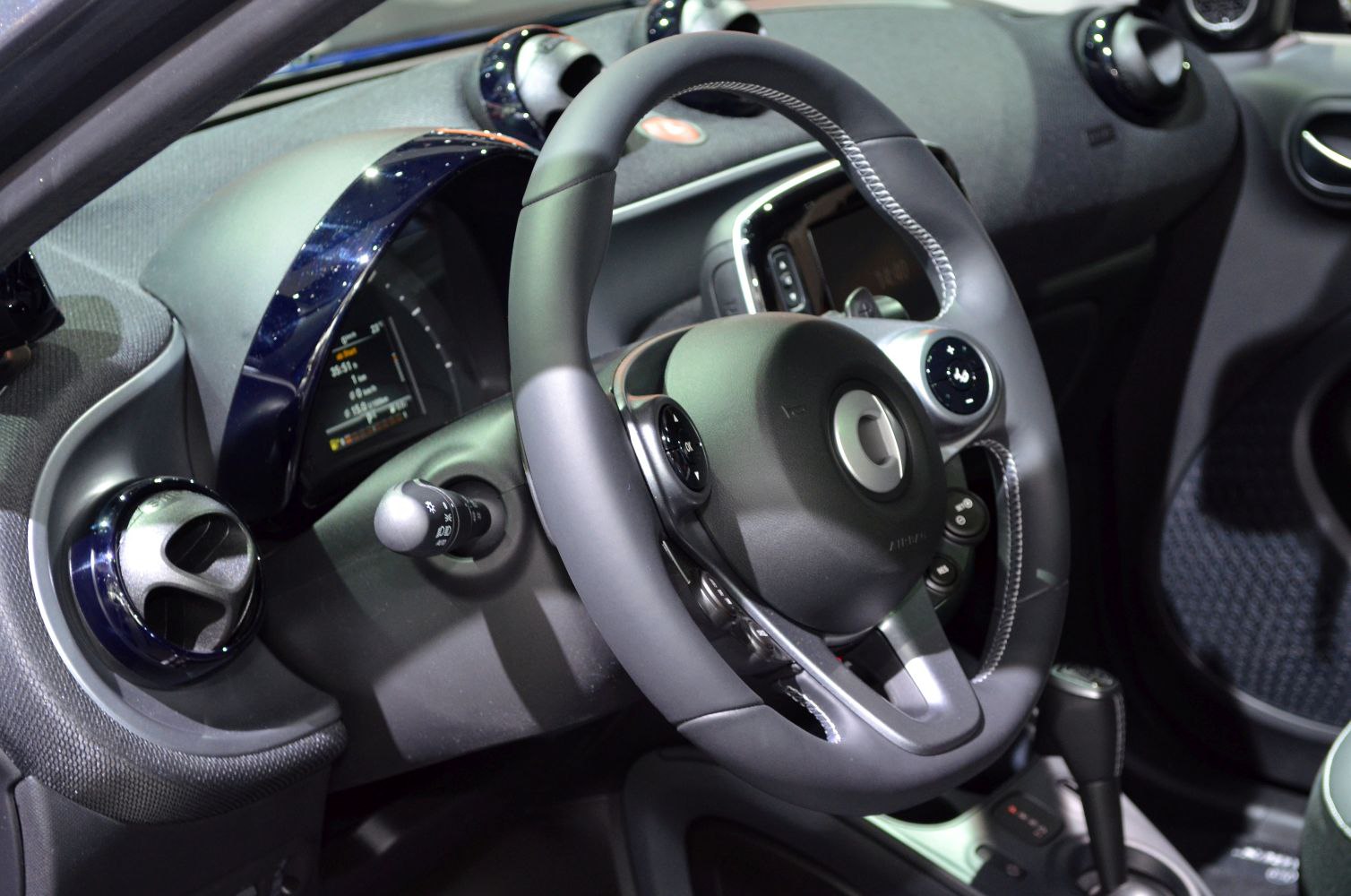 Steering wheel and digital dashboard with air vents in car interior