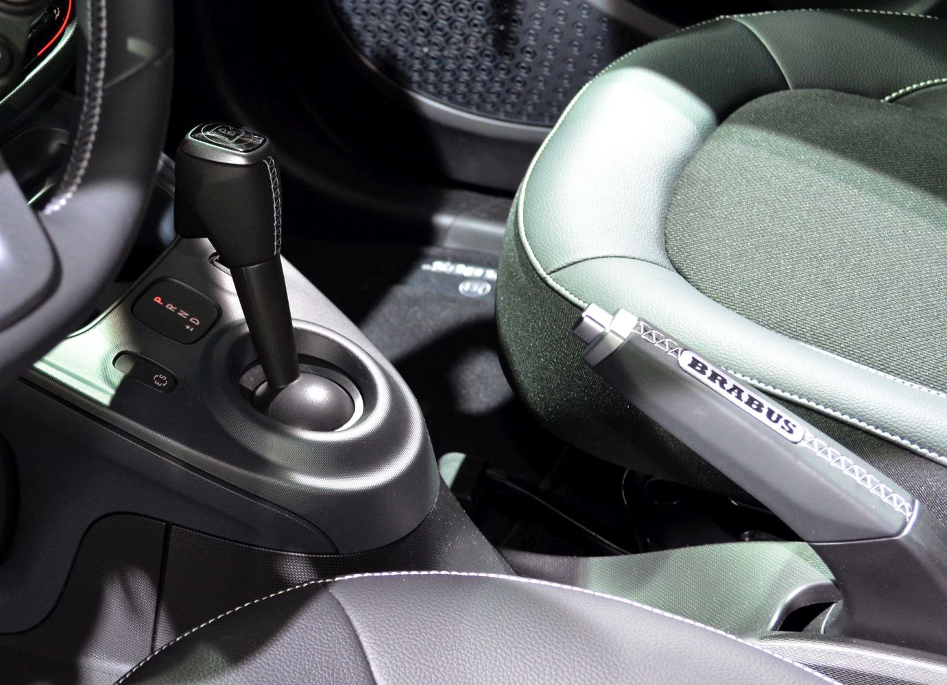 Close-up of gear shift and Brabus branded handbrake in car interior