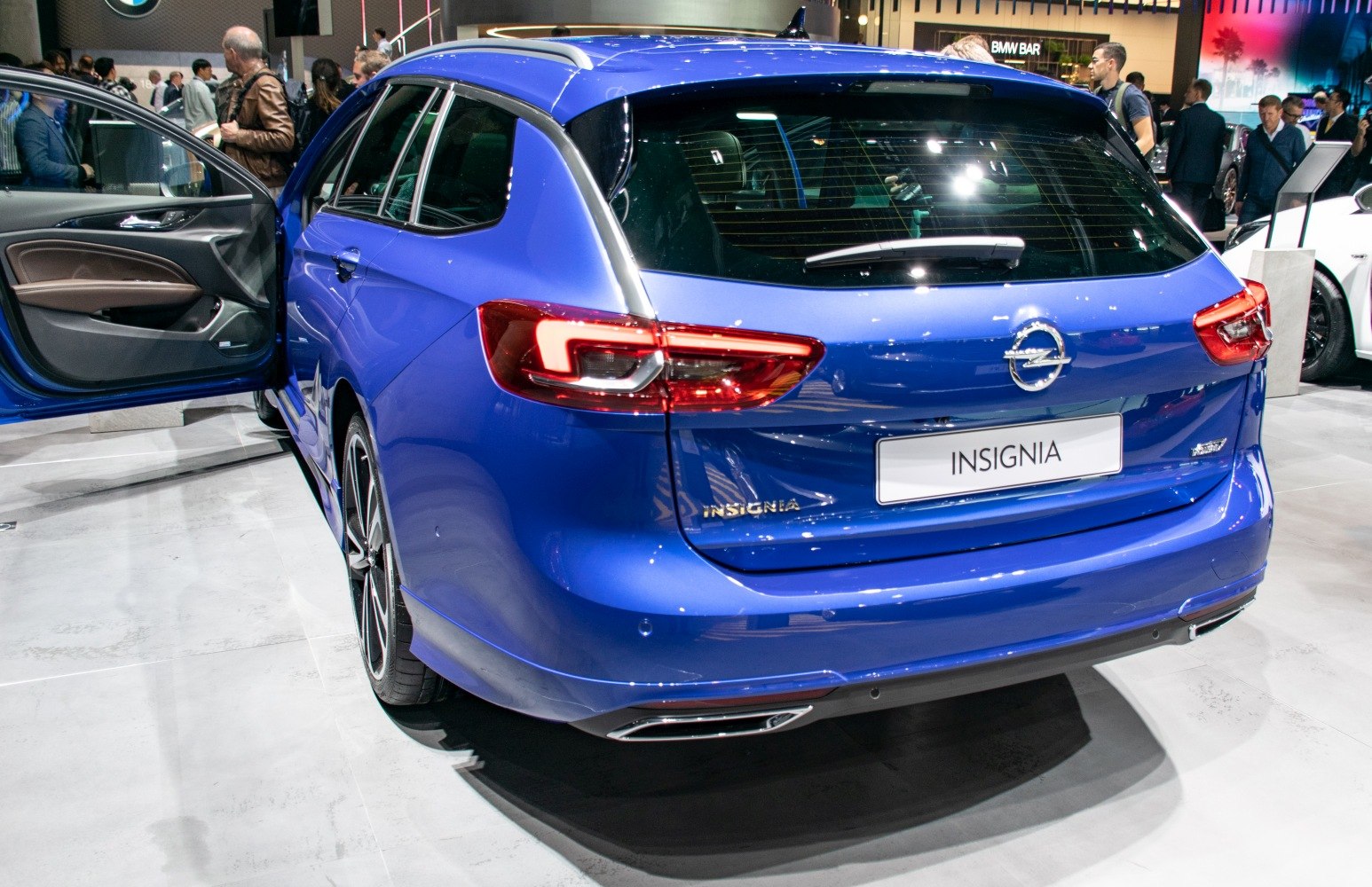 Blue station wagon rear with taillights and dual exhausts
