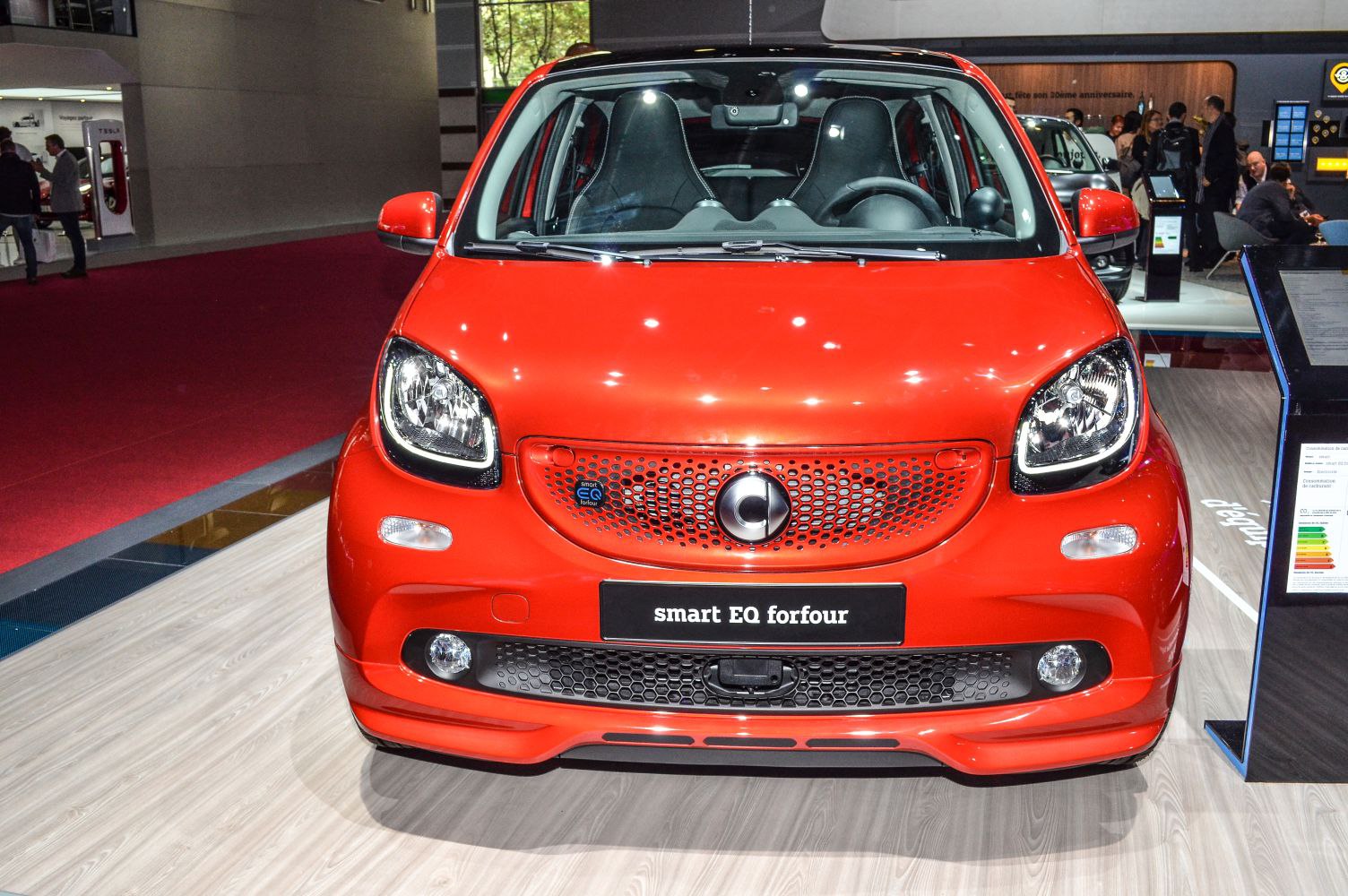Front view of a compact electric hatchback with distinct headlights and honeycomb grille.