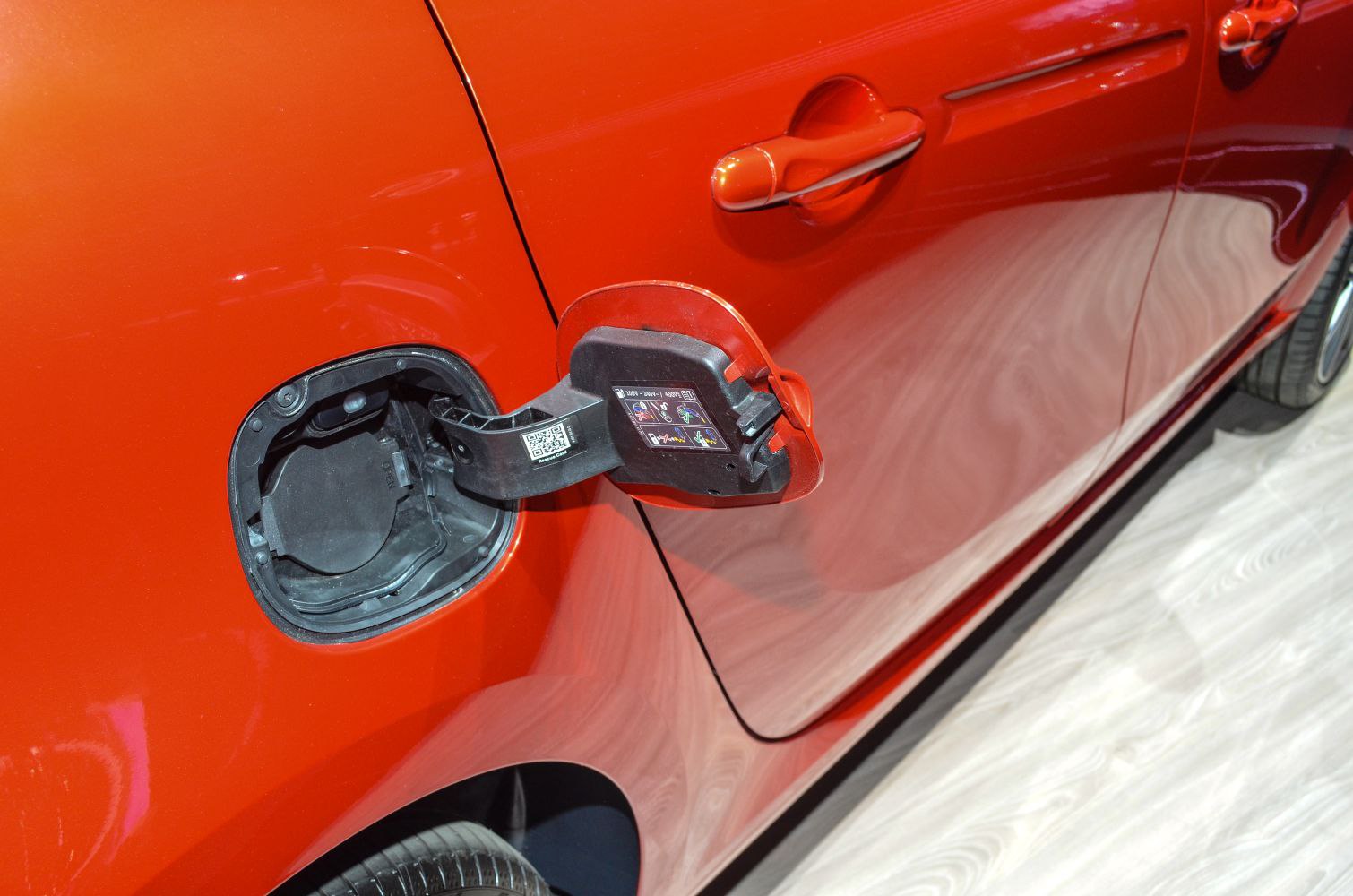 Red car fuel cap and door handle close-up