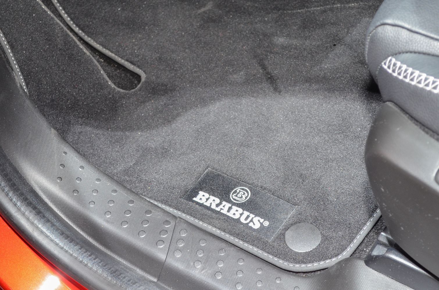BRABUS branded floor mat with textured seat stitching and interior trim.