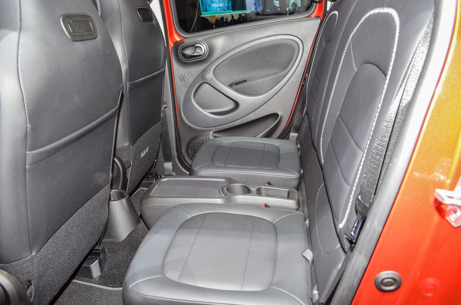 Compact rear seat with black upholstery and central console