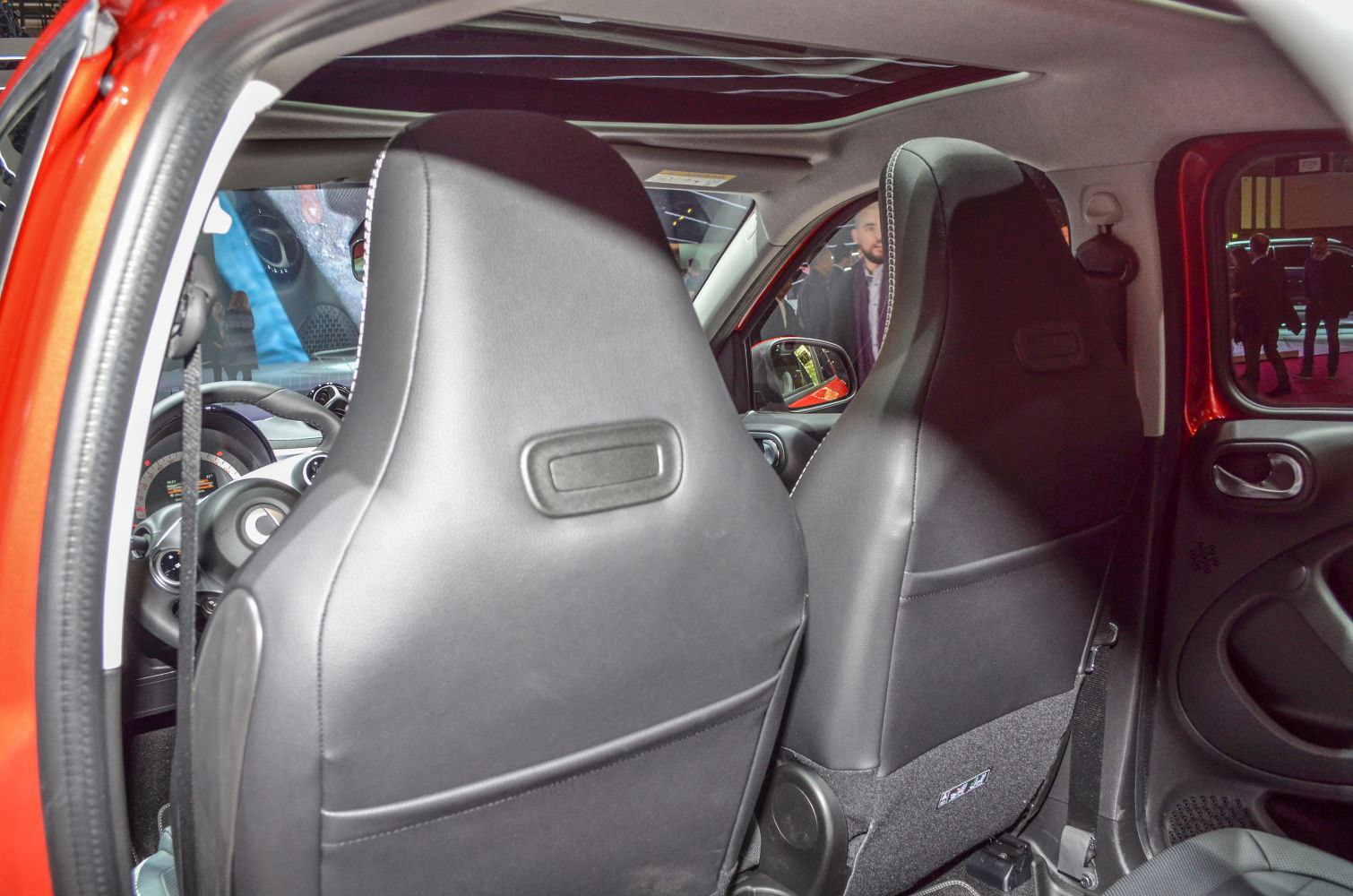 Front black leather seats and dashboard interior in a compact vehicle