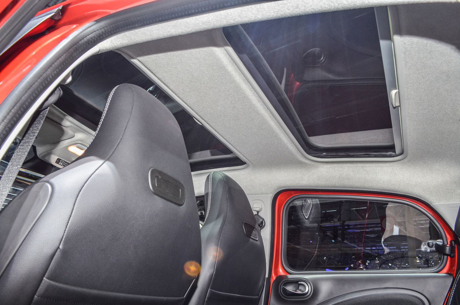 Black front seats and panoramic sunroof inside compact car