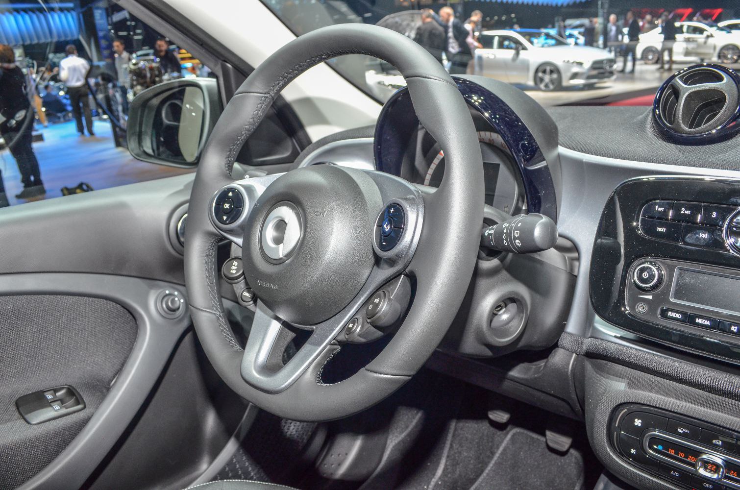 Steering wheel and dashboard with controls