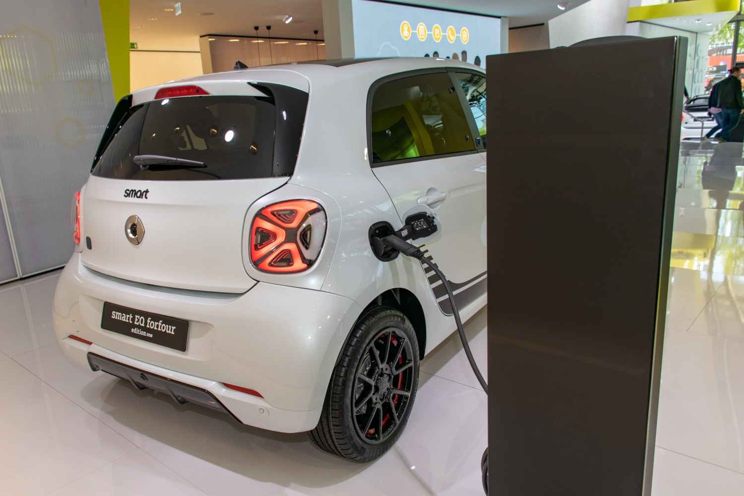 Compact electric hatchback rear with charging port connected to station