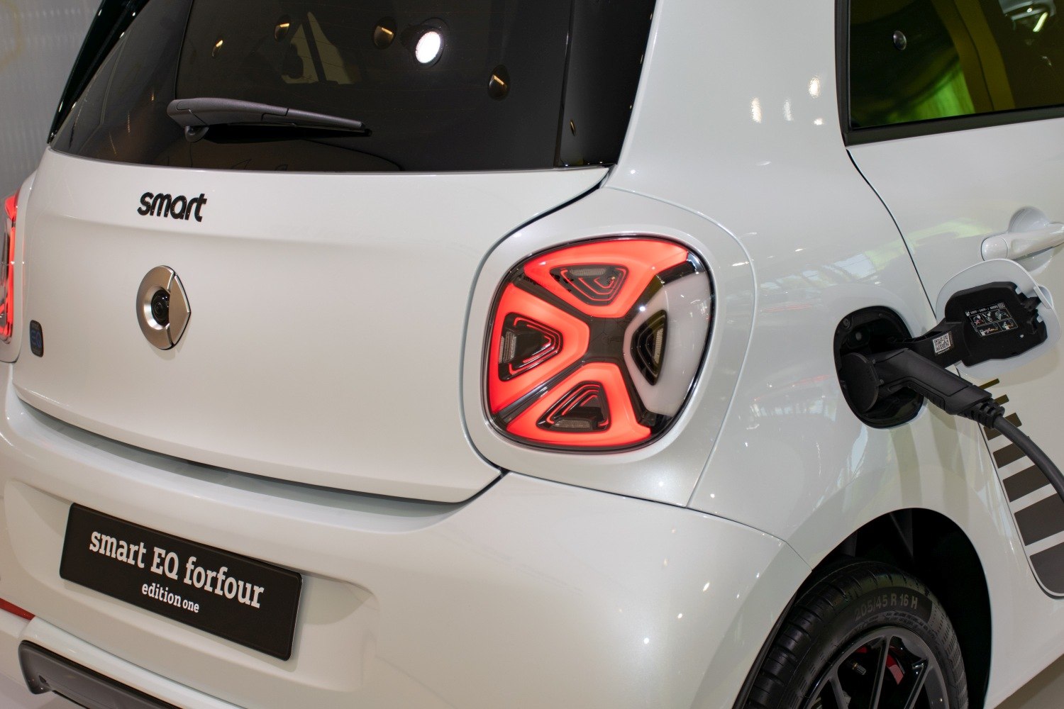 Rear tail light and electric charging port on compact electric vehicle