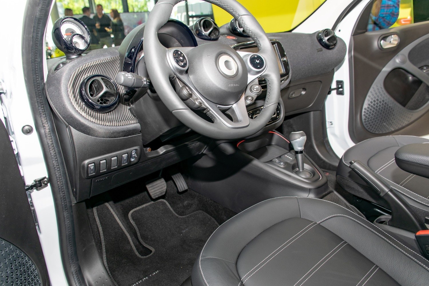 Steering wheel and dashboard with center console featuring gear shift and controls