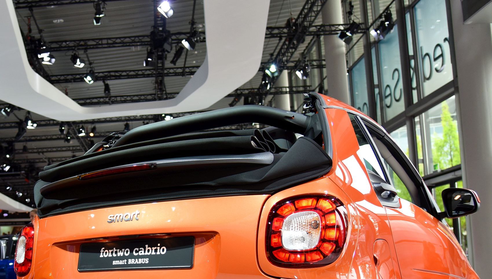 Rear view of compact convertible with folded soft top and distinct tail lights