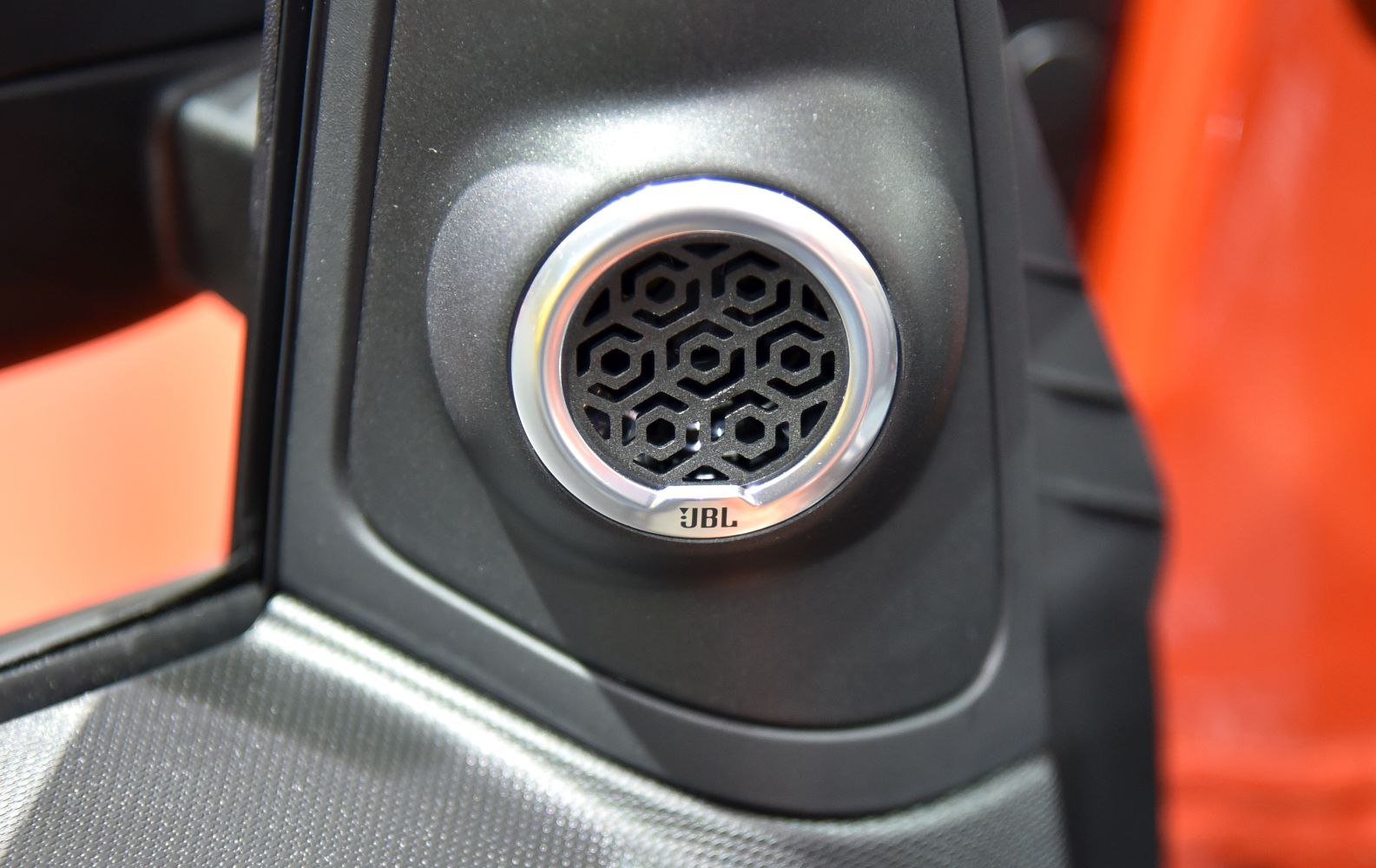 JBL branded circular speaker grille with hexagonal pattern