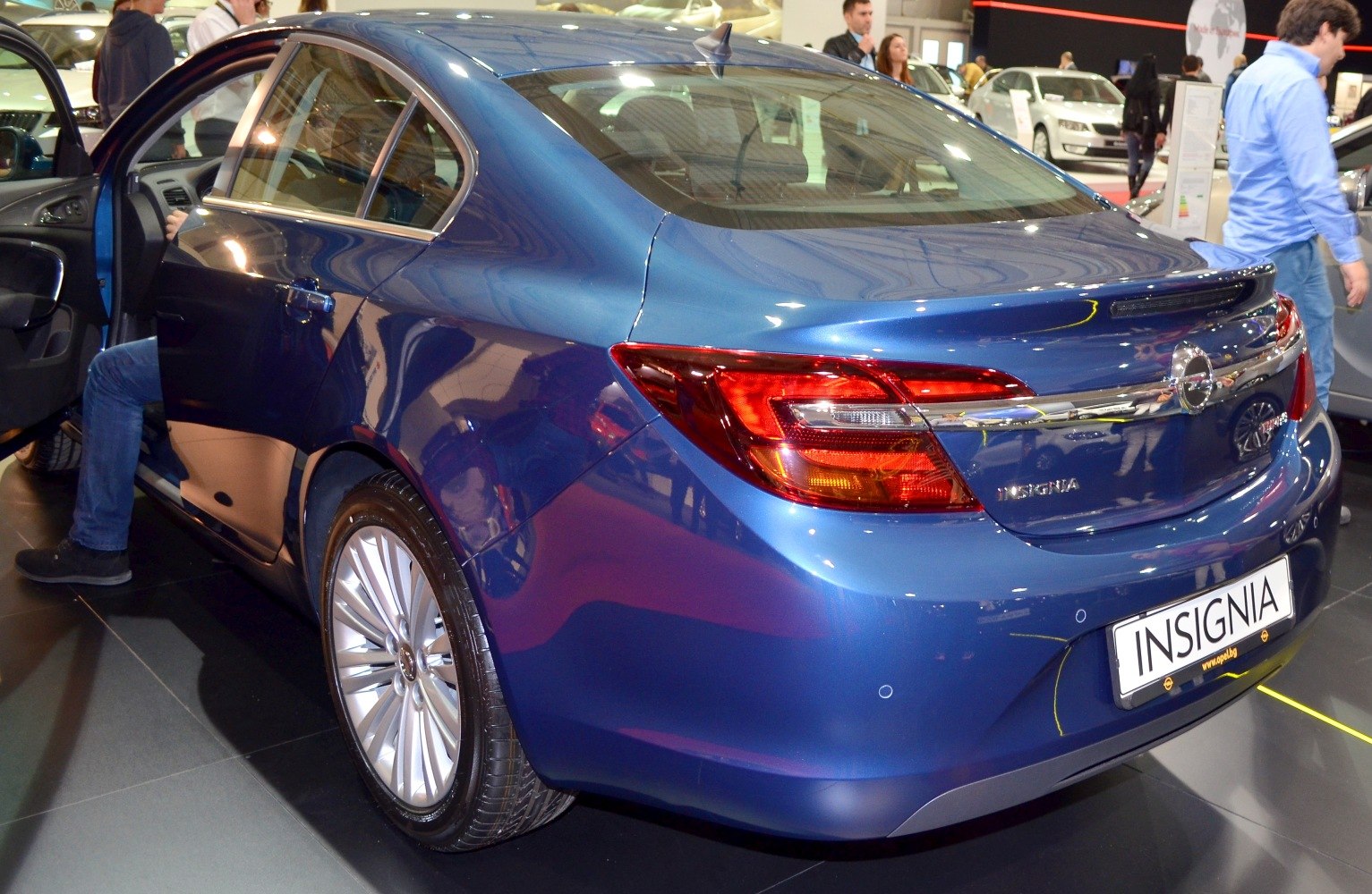 Rear view with distinct tail lights and blue sedan body
