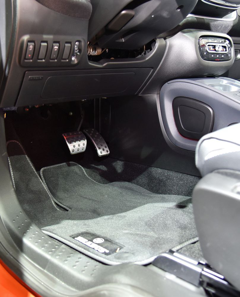 Foot pedals and lower dashboard panel in a compact car interior