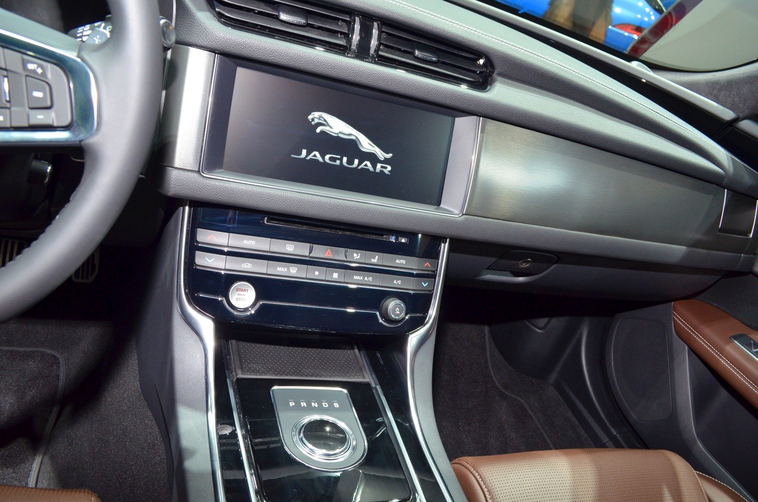 Rotary gear selector and modern infotainment screen in luxury car interior