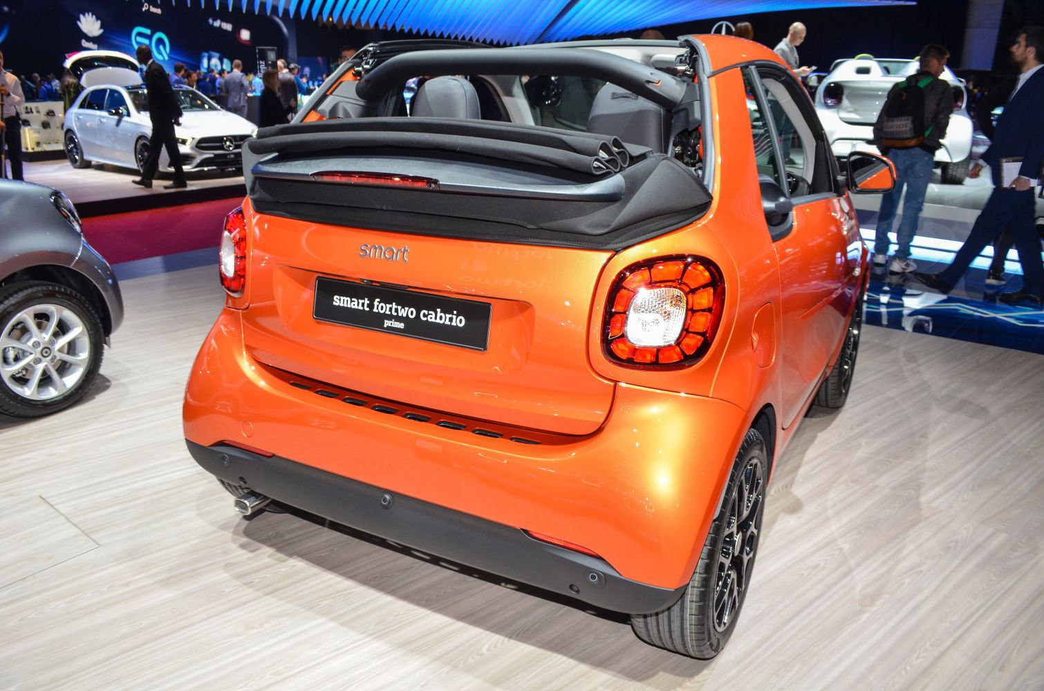Rear view of convertible Smart Fortwo with folded soft top roof and distinct tail lights