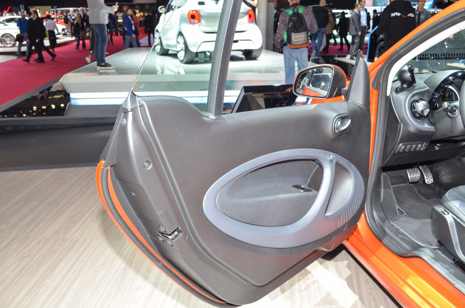 Interior door panel with handle and window controls of a compact convertible.
