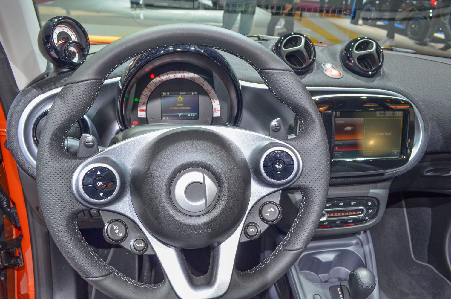 Steering wheel and dashboard with digital speedometer and infotainment display
