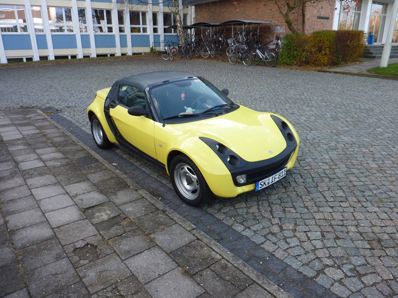 Yellow convertible with black accents and rounded headlights