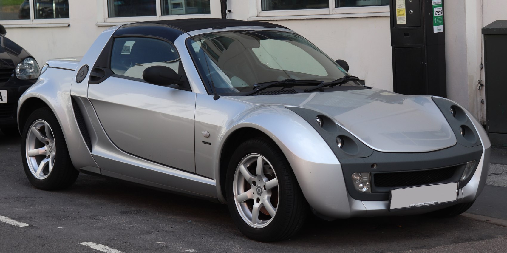 Silver sporty small two-seater convertible with unique headlights and alloy wheels