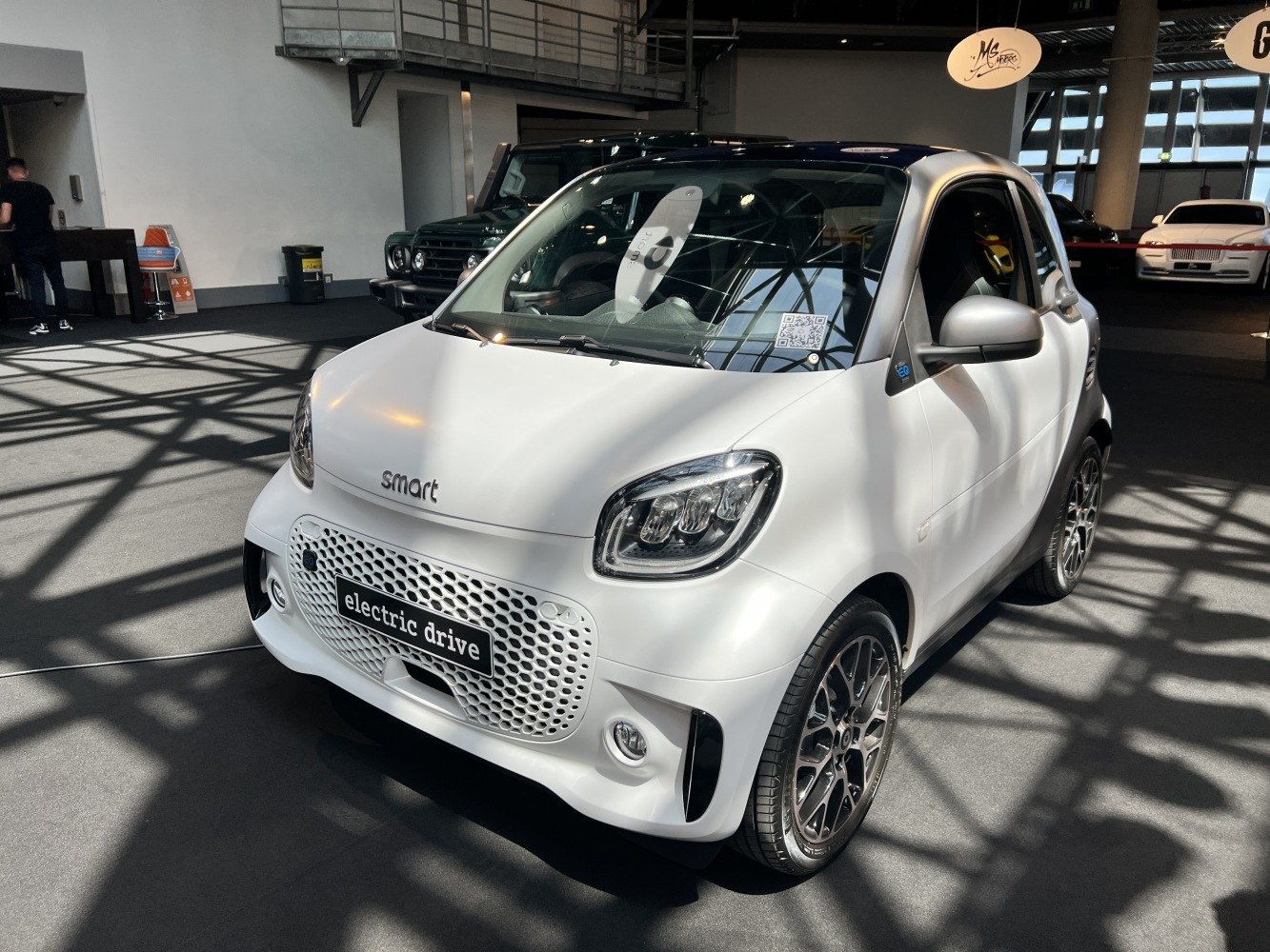 Compact electric vehicle front view with modern headlights and grille