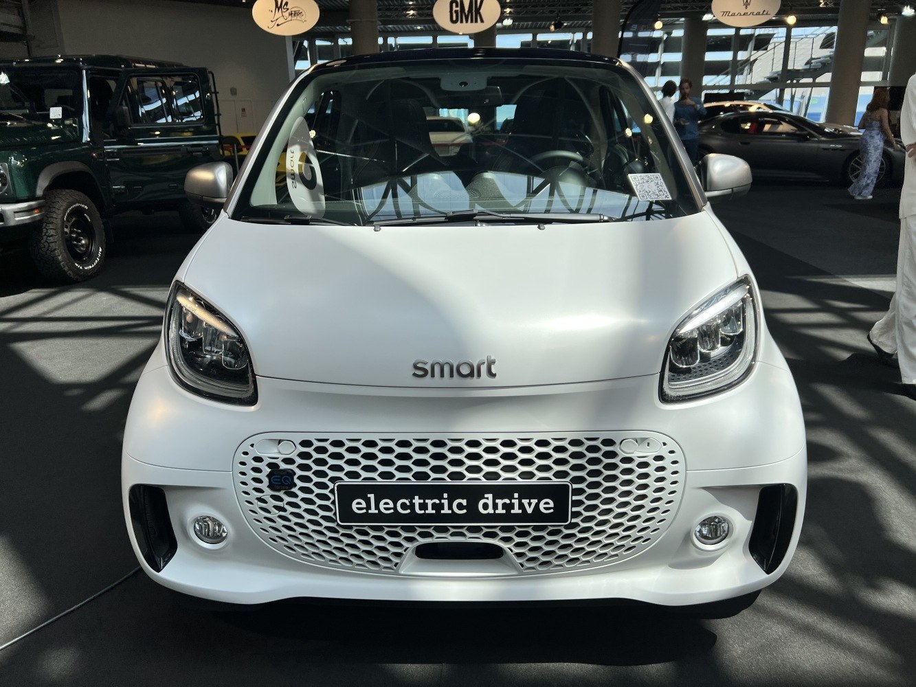 Compact electric car front with LED headlights and honeycomb grille