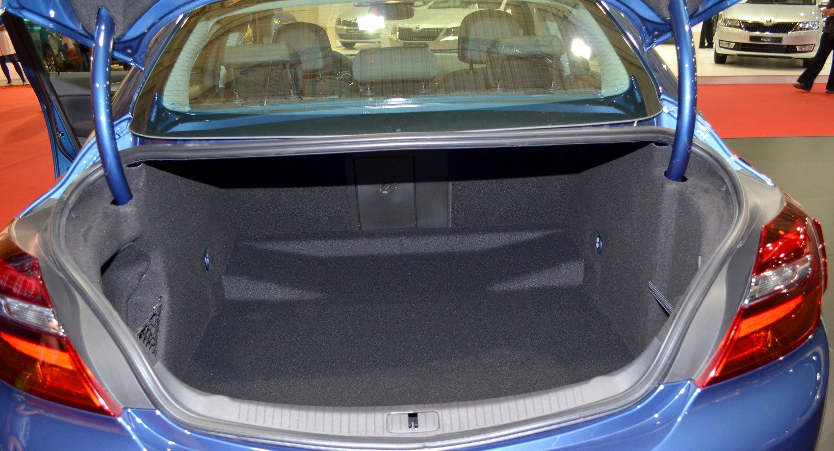 Spacious carpeted rear trunk interior with open lid