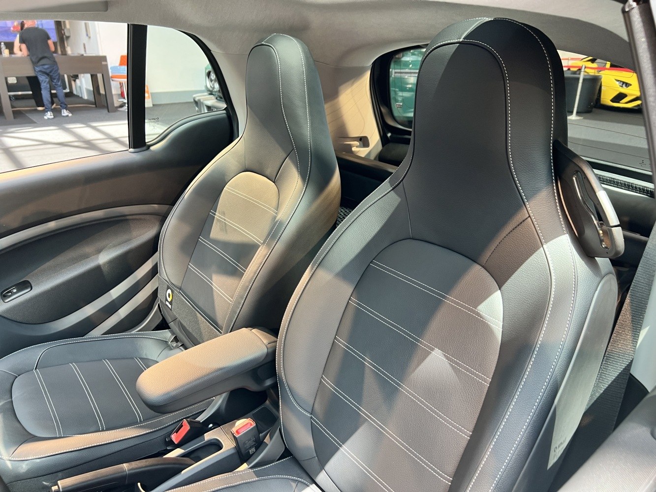 Close-up of ergonomic leather front seats with contrast stitching.