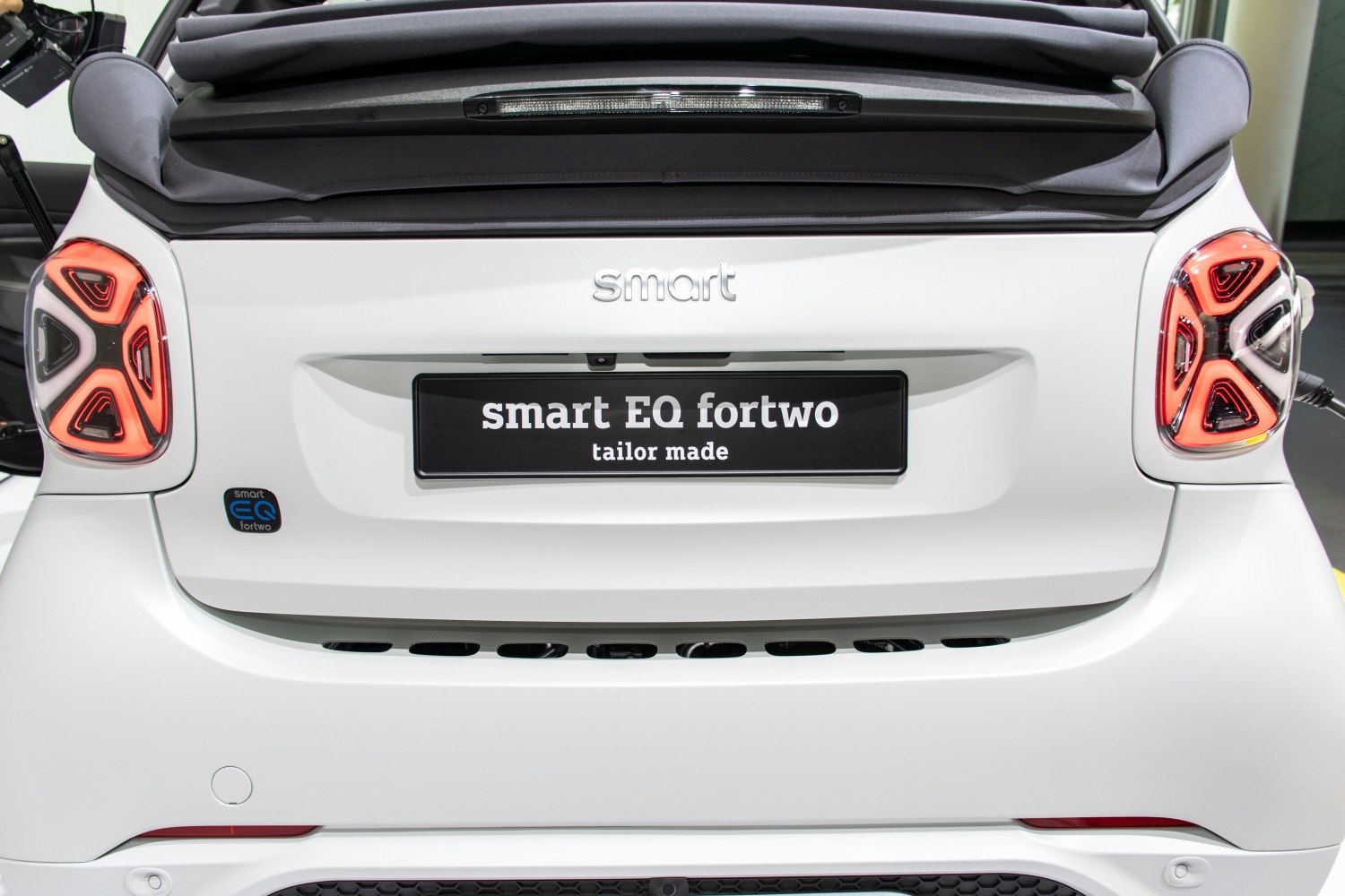 Rear view with distinctive tail lights on compact electric convertible