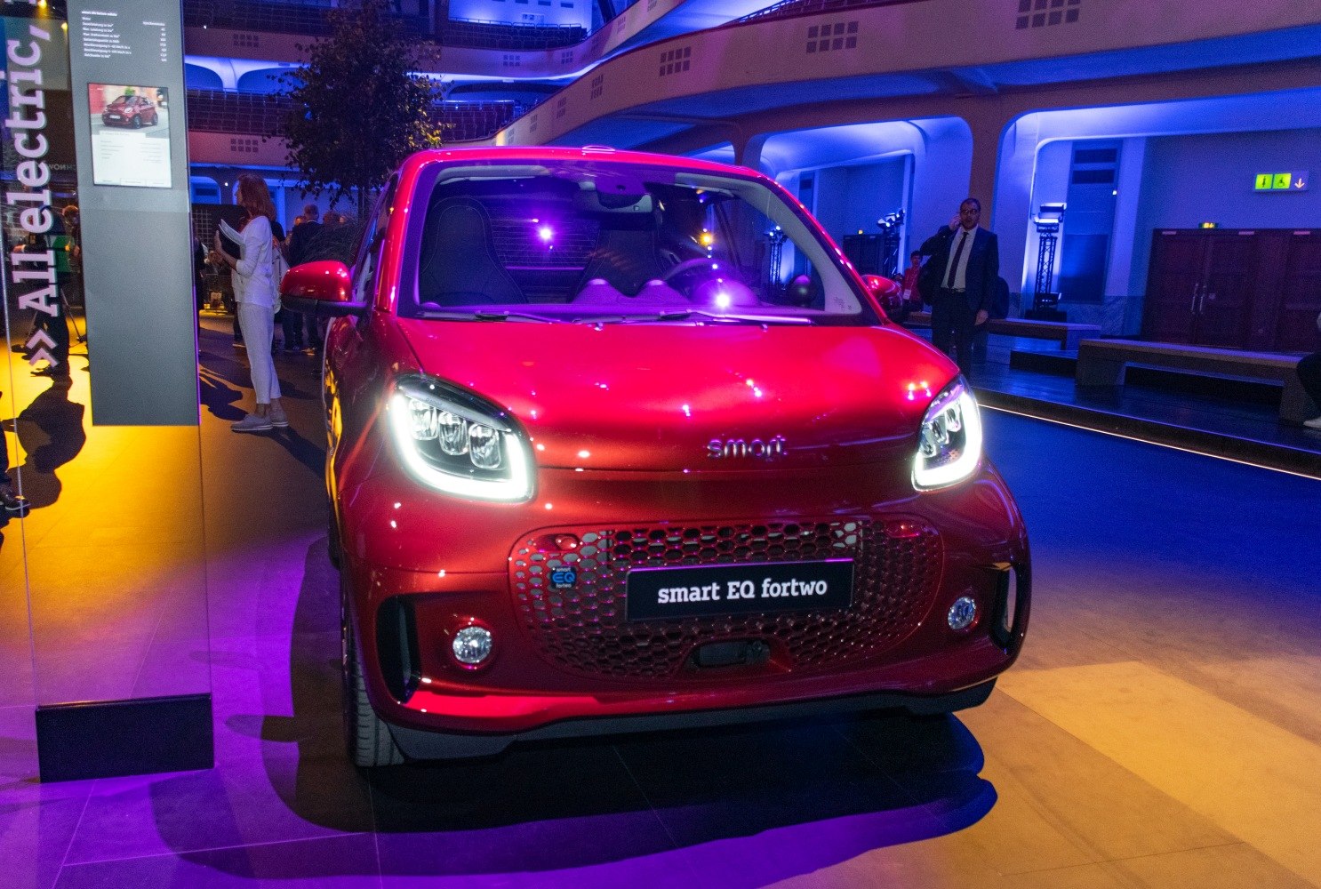 Front view with illuminated LED headlights and honeycomb grille