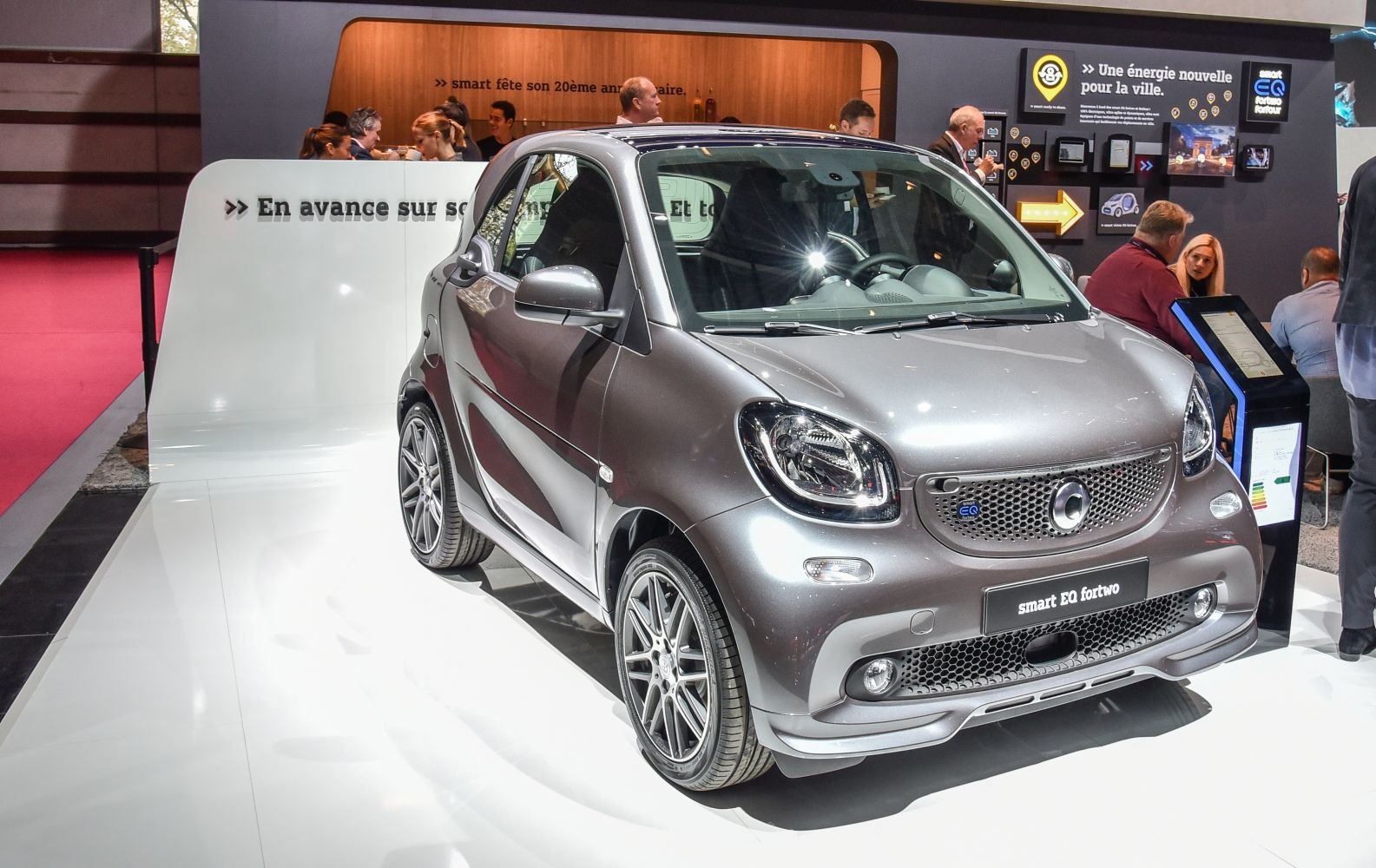 Compact electric two-seater car with modern design and aerodynamic front end.