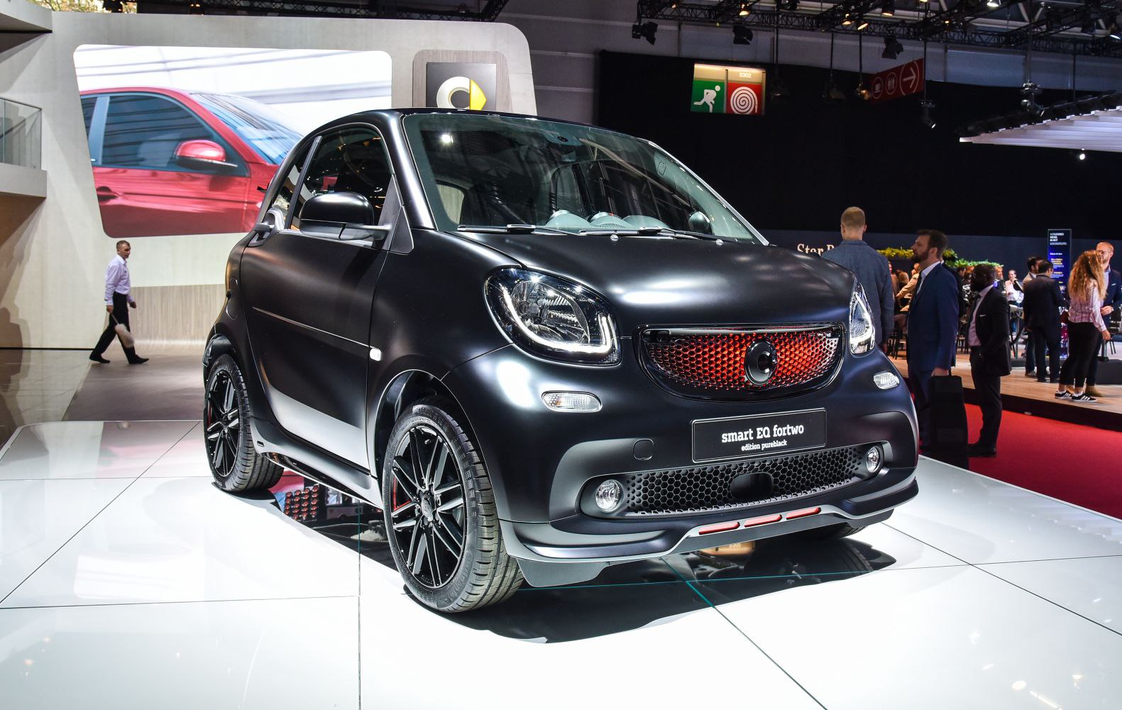 Matte black microcar front and side with LED headlights and distinctive grille
