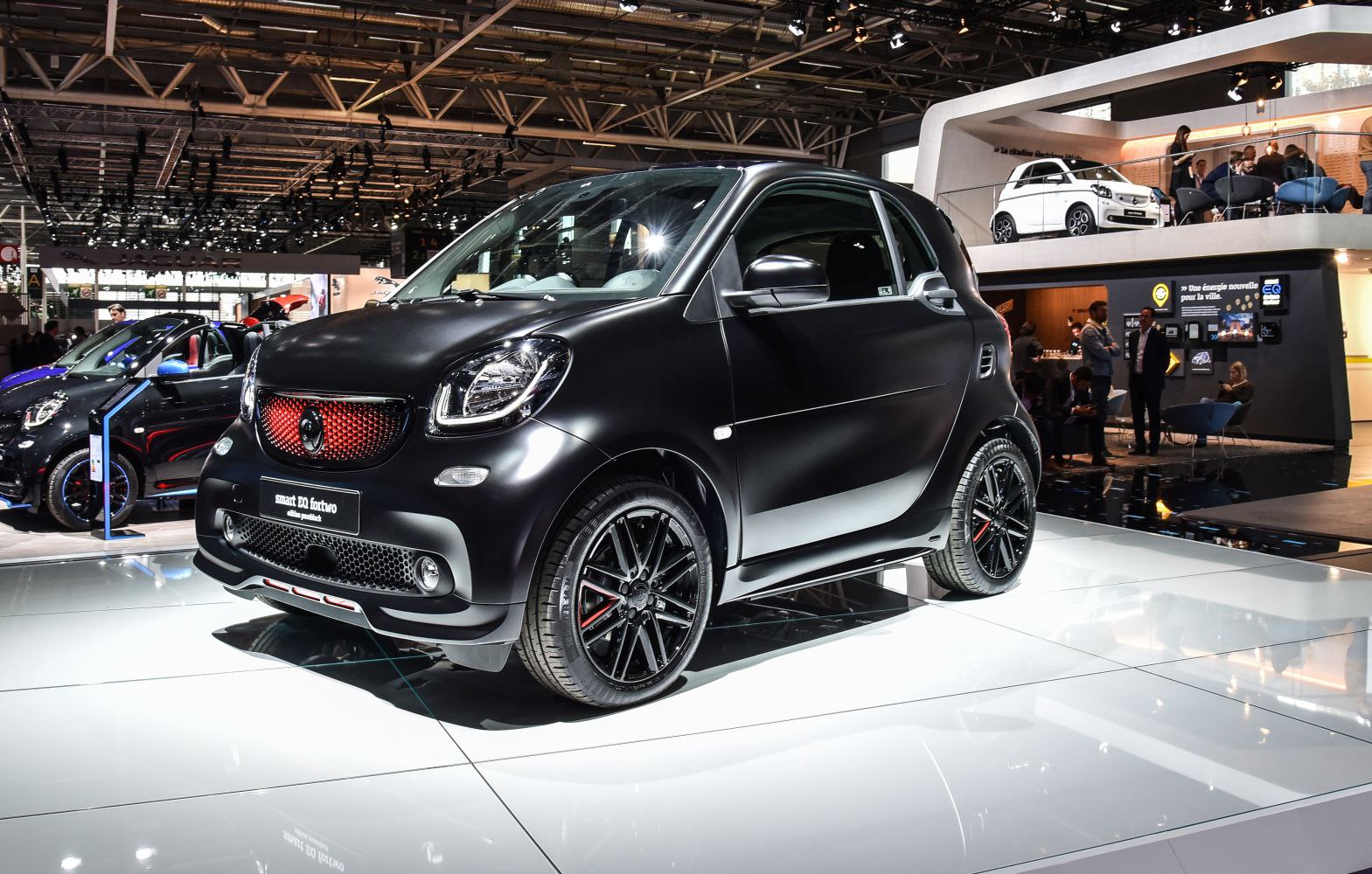 Matte black compact electric car with sporty front grille and alloy wheels