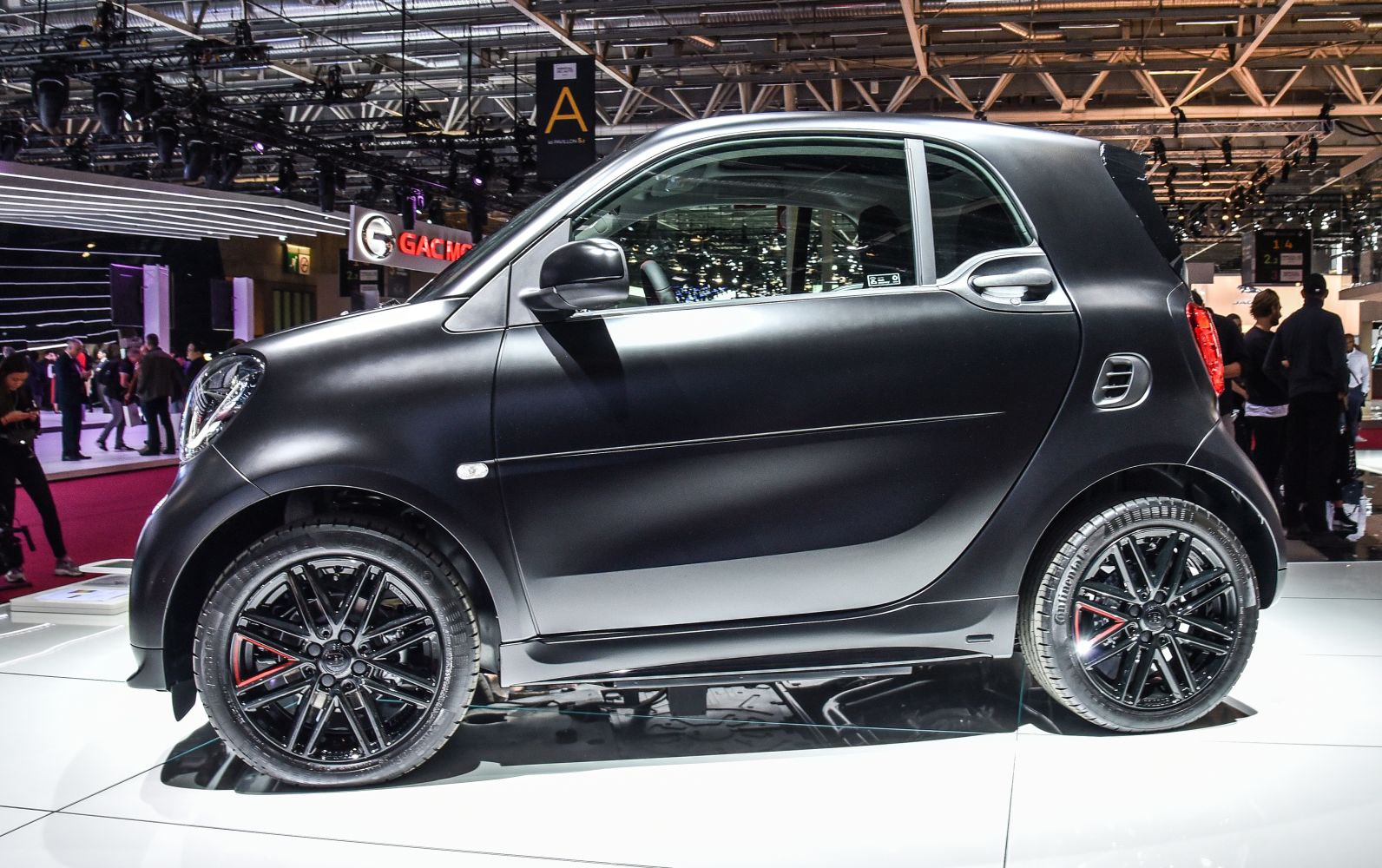 Matte black two-door hatchback with sporty black wheels