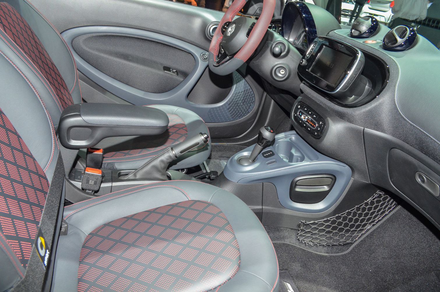 Compact electric car interior with patterned seats and digital dashboard