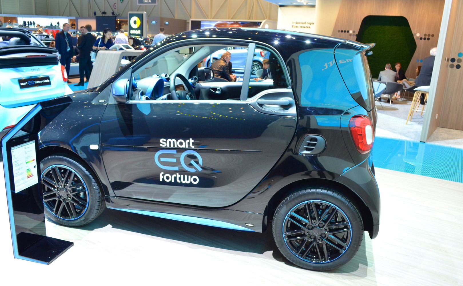 Compact electric microcar side profile with black alloy wheels