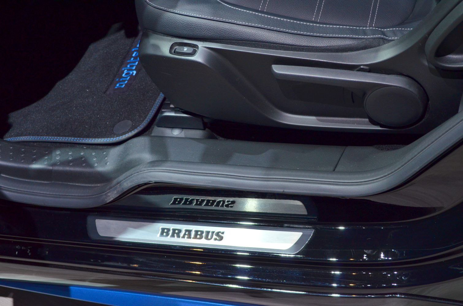 Brabus door sill plate with driver seat adjustment lever and car floor mat