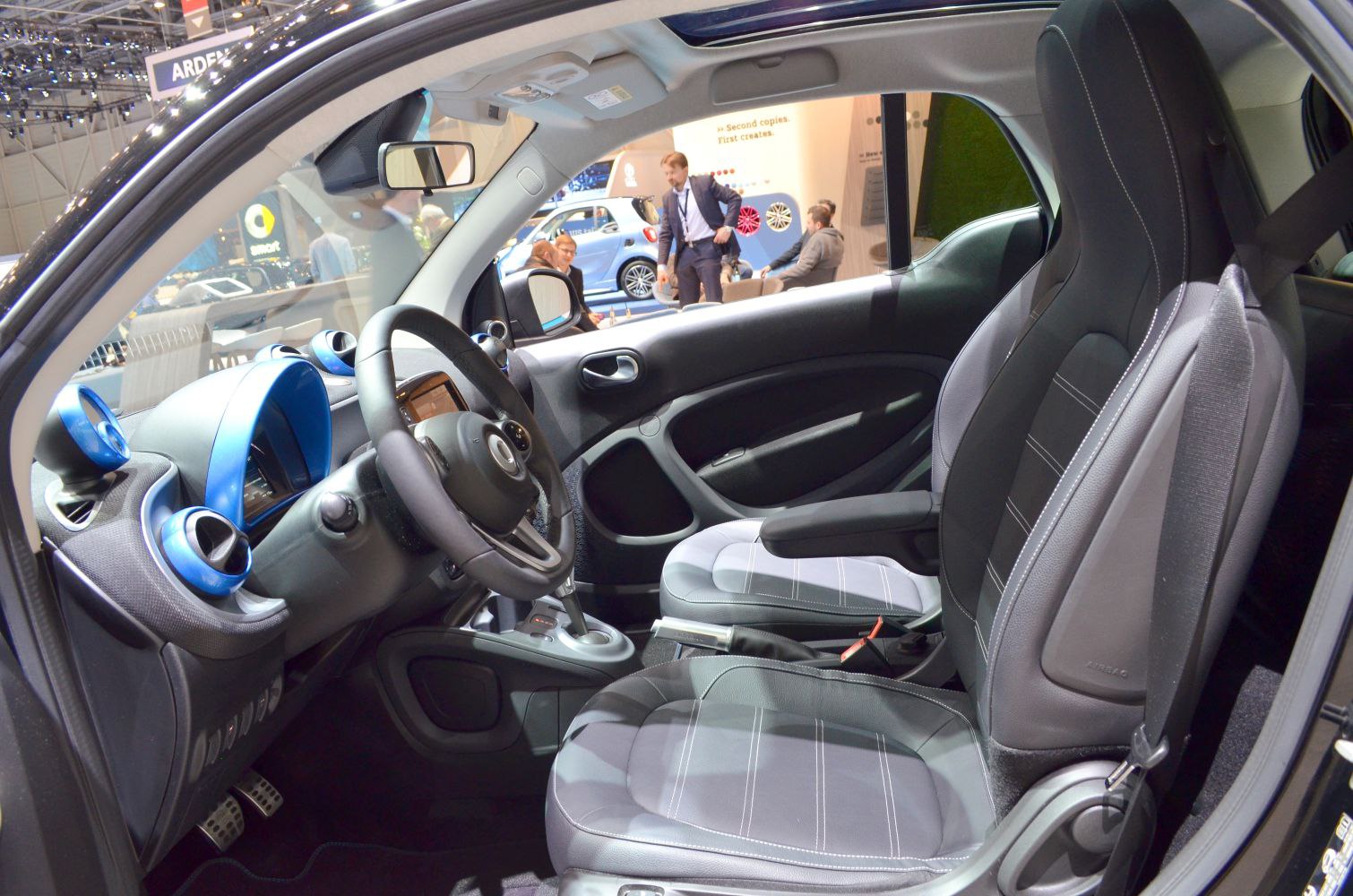 Modern dashboard and front seats of a compact electric vehicle interior