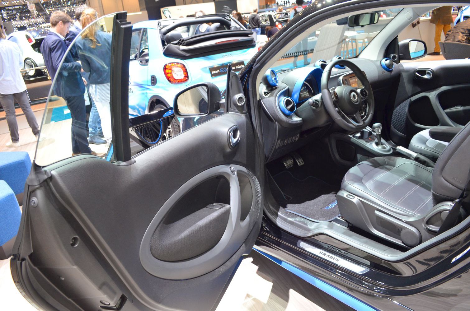 Compact electric car interior with detailed dashboard and seating
