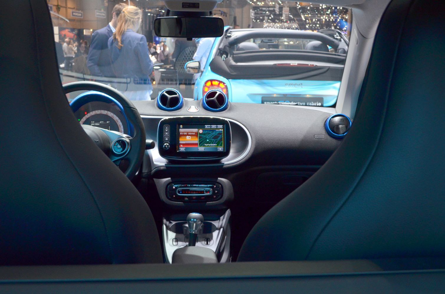 Compact car interior with infotainment screen and circular air vents