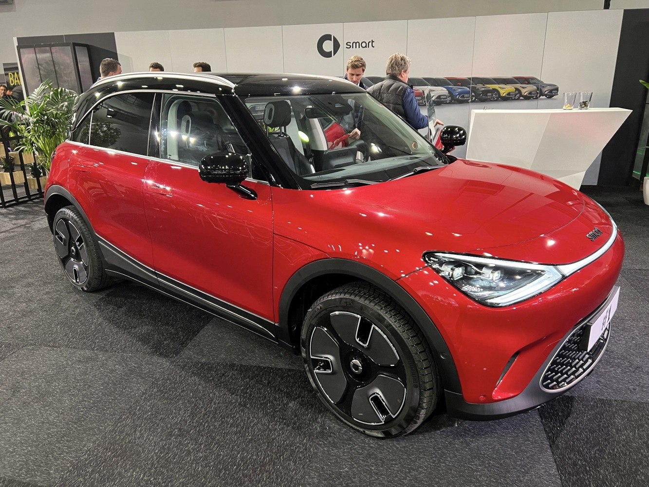 Red electric crossover with LED headlights and modern wheels
