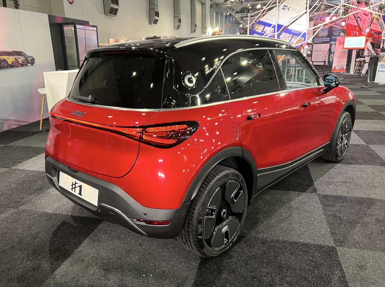 Rear and side view of red SUV with black roof and LED taillights