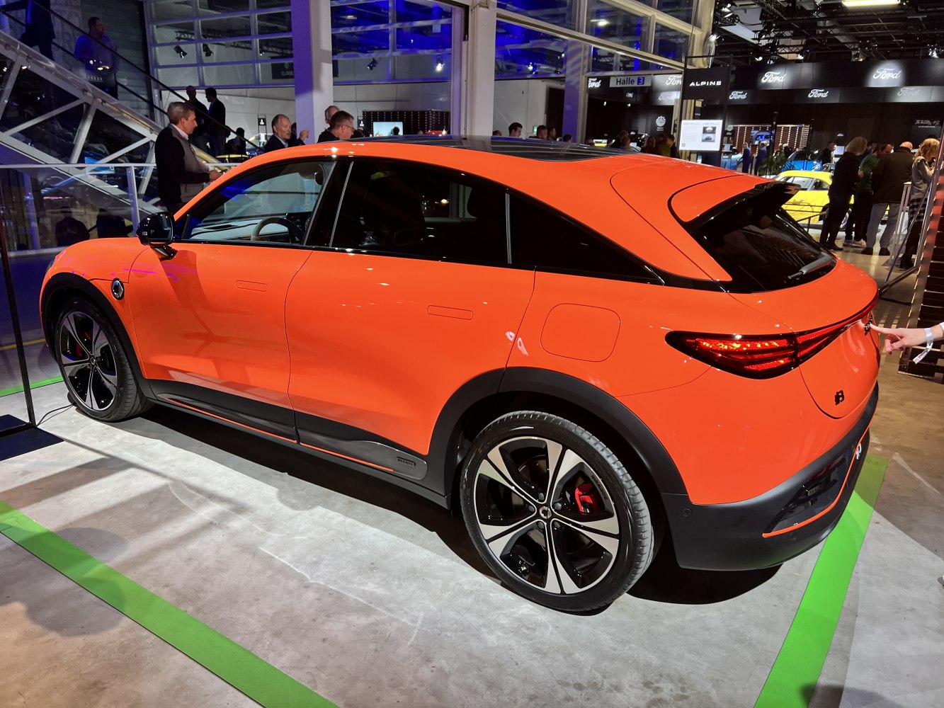 Vibrant modern compact electric vehicle with sleek rear and sporty alloy wheels