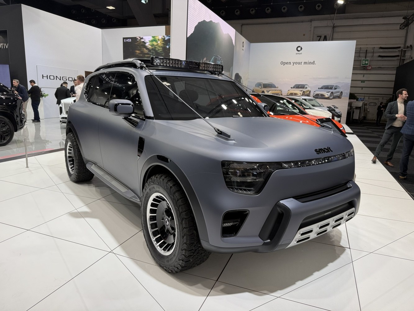 Off-road SUV with wide tires, roof light bar, aerodynamic matte finish