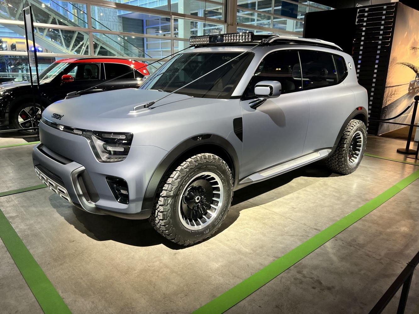 Electric SUV with rugged tires and bold futuristic headlights