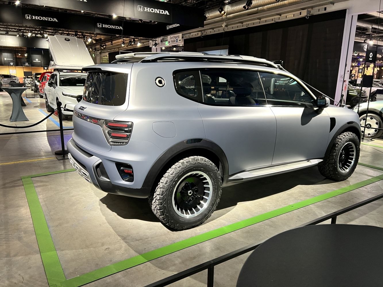 Futuristic compact SUV with off-road tires and matte paint finish