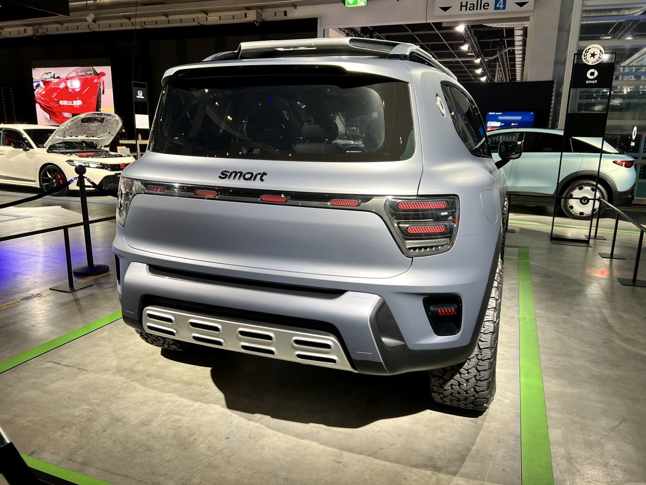 Rear view with futuristic LED taillights and offroad tires